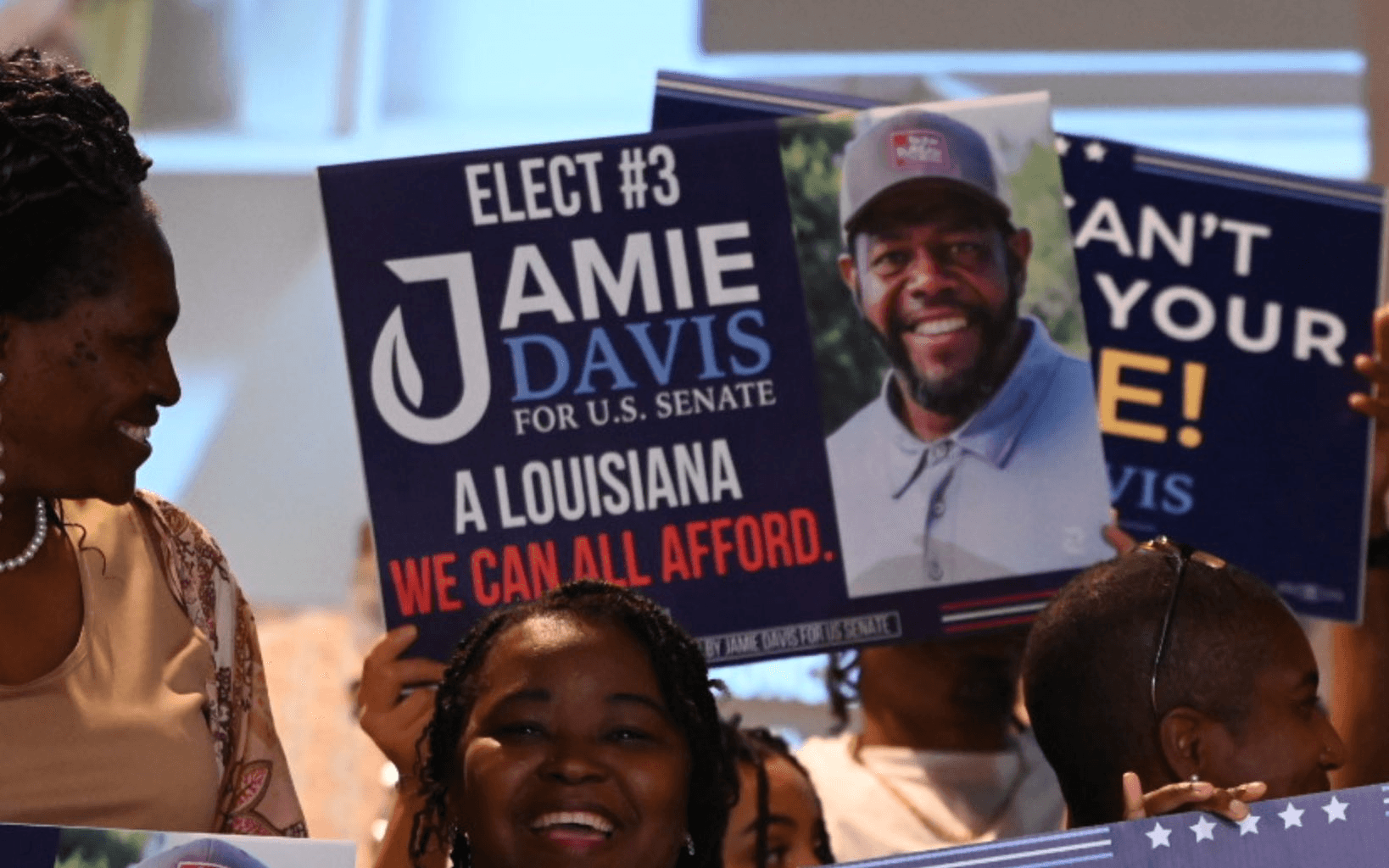 A crowd of supporters holding Jamie Davis signs on primary night