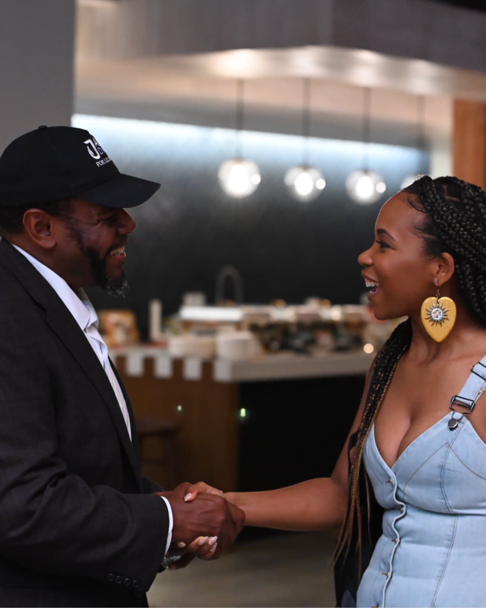 Jamie Davis shaking hands with a supporter at an NAACP town hall