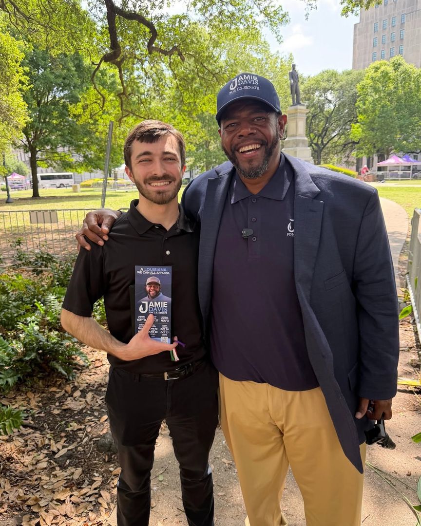 A volunteer with a Jamie Davis flyer at a downtown event