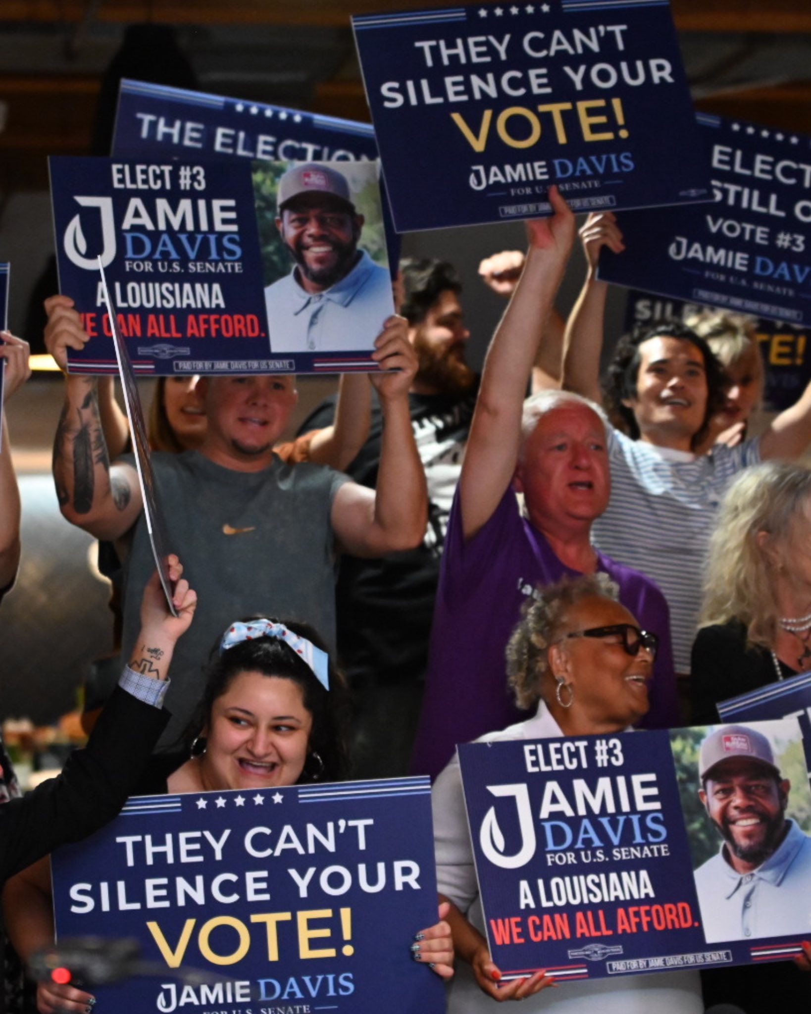 A crowd holding campaign signs
